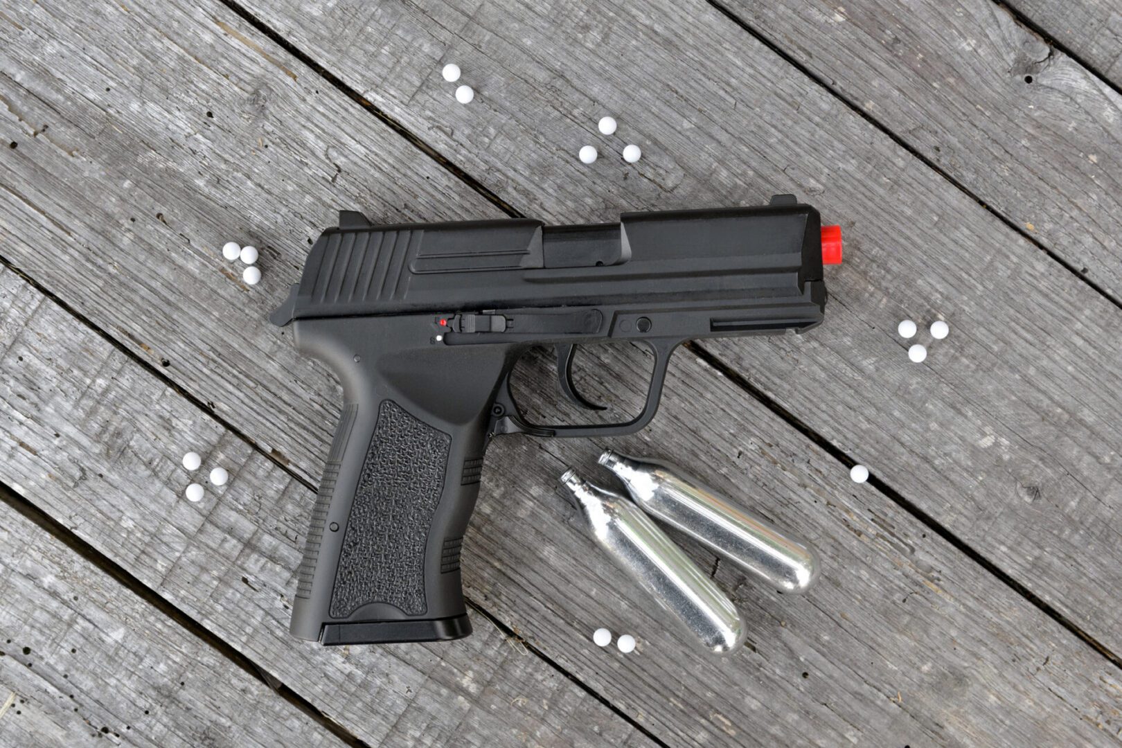 Airsoft equipment on wooden surface